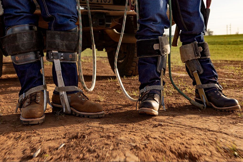 Two men wearing Chippewa Logger boots.